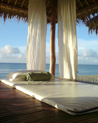 a luxurious bedroom setup on the beach